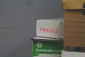 A stack of moving boxes, including one that reads “fragile”